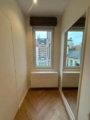 an empty room with two windows and a mirror at Hotel Room - Centrum Ghent Leie in Ghent