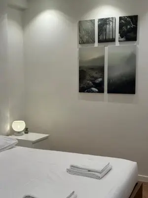 a white room with a bed with three pictures on the wall at Hotel Room - Centrum Ghent Leie in Ghent