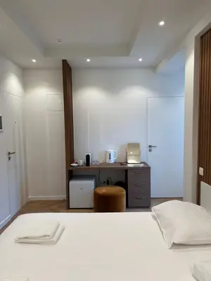 a bedroom with a bed and a desk with a laptop at Hotel Room - Centrum Ghent Leie in Ghent