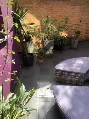 a patio with a bunch of plants and a table at Prinsenhof in Ghent