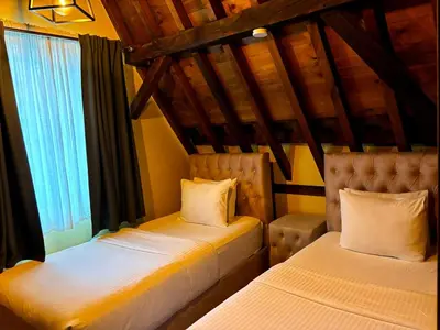 a bedroom with two beds and a window at Family Heritage Grand Place in Brussels