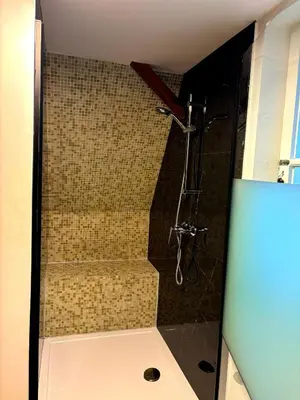 a bathroom with a shower with a glass door at Family Heritage Grand Place in Brussels