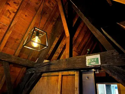a light in a wooden ceiling with a exit sign at Family Heritage Grand Place in Brussels