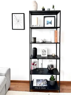 a black book shelf in a living room at Wonderful apartment in Sablon in Brussels