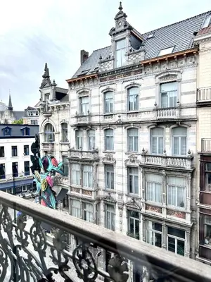 a large building with a statue in front of it at Wonderful apartment in Sablon in Brussels