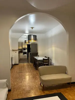 a living room with a couch and a table at Midi Tracks Apartment in Brussels