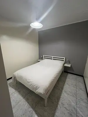 a bedroom with a white bed in a room at Midi Tracks Apartment in Brussels