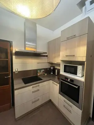 a kitchen with white cabinets and a microwave at Midi Tracks Apartment in Brussels