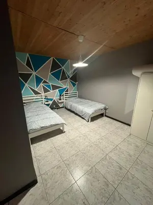 a room with two beds and a wall at Midi Tracks Apartment in Brussels