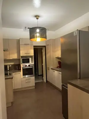 a kitchen with a stainless steel refrigerator and a light at Midi Tracks Apartment in Brussels