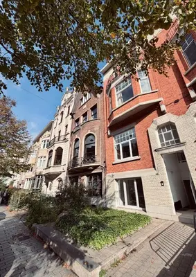 a large brick building on the side of a street at Cosy 2-Room Apartment for 4 Guests near Gent Sint-Pieters Station, and Close to the City Centre in Ghent