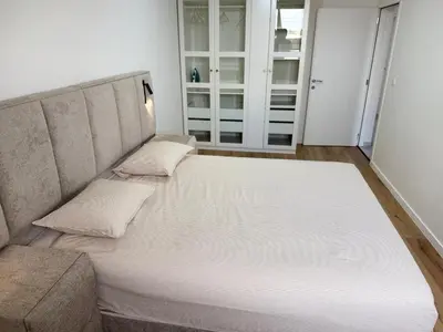 a large bed in a room with a couch at Skyline Duplex Brussels Parking Fibre Modernité in Brussels