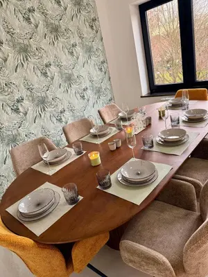 a wooden table with plates and dishes on it at Skyline Duplex Brussels Parking Fibre Modernité in Brussels