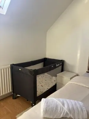 a small bedroom with a bed in the corner at littoral in Brussels
