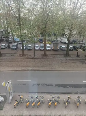 a row of bikes lined up on the side of a street at littoral in Brussels