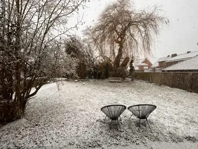 two chairs in a yard covered in snow at Cozy house in Olmen in Balen