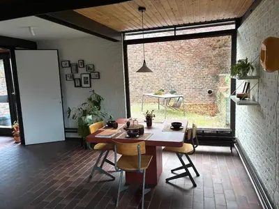 a room with a table and chairs and a large window at Cozy house in Olmen in Balen