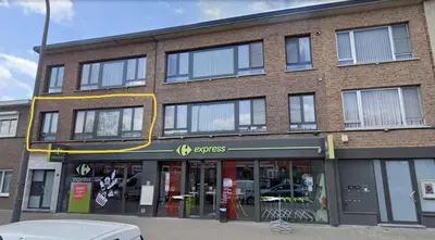 a store front of a brick building with windows at Laaglandlaan 1 in Antwerp