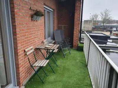 a patio with chairs and a table on a balcony at Laaglandlaan 1 in Antwerp