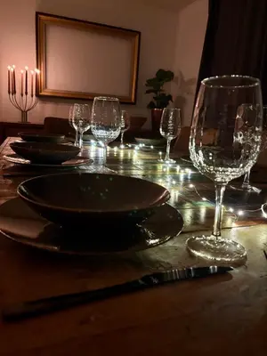 a table with plates and wine glasses on it at Bij Liezeke in Zemst