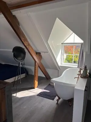 a bathroom with a white bath tub in a attic at Bij Liezeke in Zemst