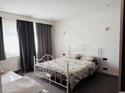a bedroom with a bed and a large window at Entire house with excellent accessibility in Machelen