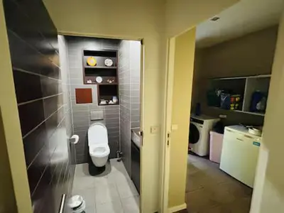a bathroom with a white toilet in a room at Entire house with excellent accessibility in Machelen