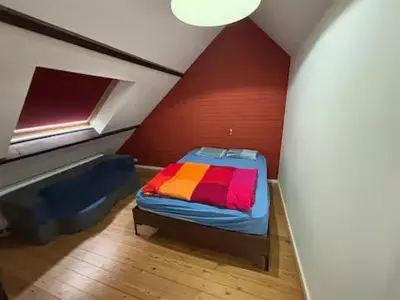 a small room with a bed in a attic at Entire house with excellent accessibility in Machelen