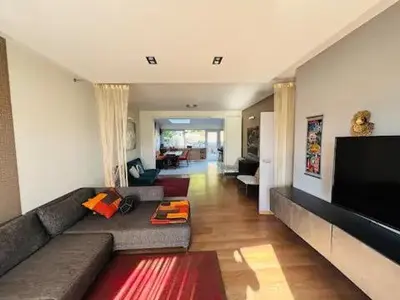 a living room with a couch and a flat screen tv at Entire house with excellent accessibility in Machelen