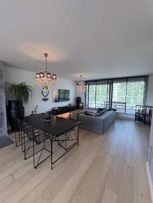 a living room with a table and a couch at Refined apartment with terraces in Brussels
