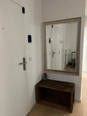 a bathroom with a mirror and a wooden table at Refined apartment with terraces in Brussels