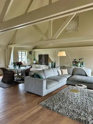 a living room with a couch and a table at De Loft in Melsele