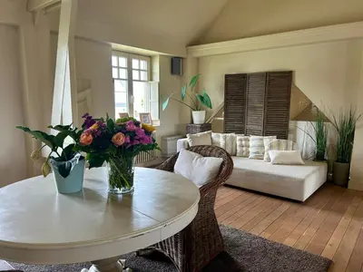 a living room with a table and a couch at De Loft in Melsele