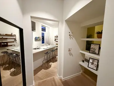 a kitchen with a bar and stools in a room at Studio 204 cosy au centre de Bruxelles in Brussels