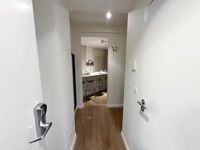 a door to a hallway with a kitchen in the background at Studio 204 cosy au centre de Bruxelles in Brussels