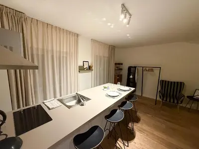 a kitchen with a counter with stools around it at Studio 204 cosy au centre de Bruxelles in Brussels