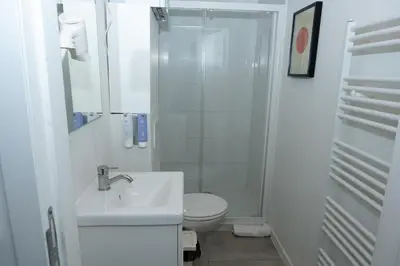 a bathroom with a toilet and a sink and a shower at Studio 204 cosy au centre de Bruxelles in Brussels
