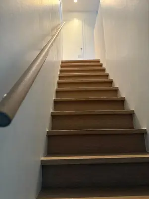 a staircase in a building with wooden steps at The Central Experience - 2 BR, Bright, Spacious & Central in Brussels
