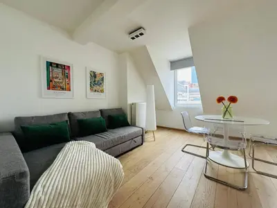 a living room with a couch and a table at The Central Experience - 2 BR, Bright, Spacious & Central in Brussels