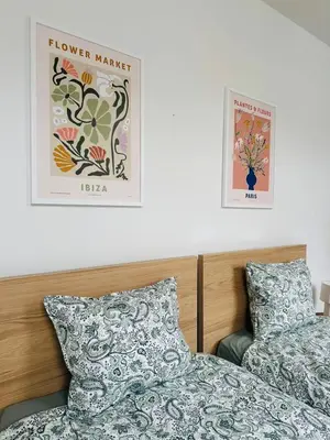 a bedroom with two beds and two posters on the wall at The Central Experience - 2 BR, Bright, Spacious & Central in Brussels