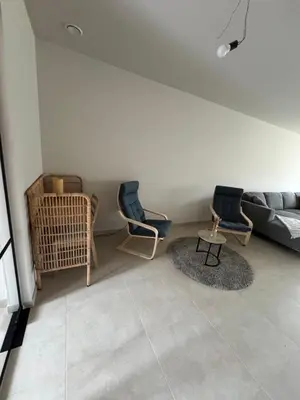 a living room with two chairs and a couch at Maison frère in Berlare