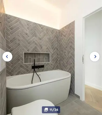 a bathroom with a tub and a toilet in it at Groot rustgevend huis met dakterras uitzicht op het groen kwartier van Berchem in Antwerp