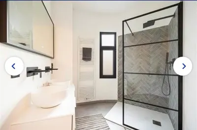 a bathroom with a glass shower and a sink at Groot rustgevend huis met dakterras uitzicht op het groen kwartier van Berchem in Antwerp