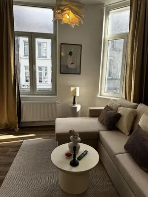 a living room with a couch and a table at Lovely 1BR & 1LR Apartment, Only 15 Min Walk to City Center in Ghent