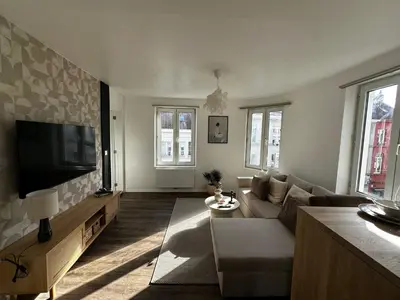 a living room with a couch and a flat screen tv at Lovely 1BR & 1LR Apt for 4P, Only 15 Min Walk to City Center in Ghent