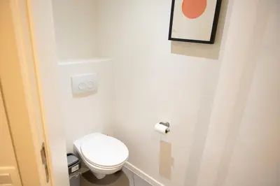 a bathroom with a white toilet in a room at Studio 402 Avenue Louise in Brussels