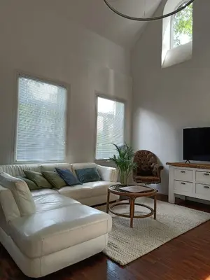 a living room with a white couch and a table at De Steeg in Kalmthout
