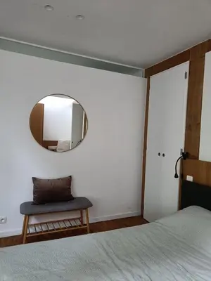 a bedroom with a bed and a mirror on the wall at De Steeg in Kalmthout