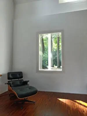a chair in an empty room with a window at De Steeg in Kalmthout
