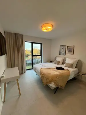 a bedroom with a large bed and a large window at Luxury Apartment Antwerp Port Moerbeke 2 in Lokeren